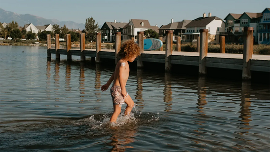 waterproof wound cover on young child in a lake